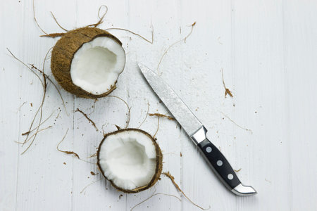 two coconut pulp fresh tropical brown white organic coconut coconut flakes milk knifeの写真素材
