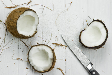 two coconut pulp fresh tropical brown white organic coconut coconut flakes milk knifeの写真素材
