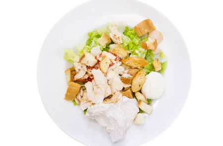isolation Caesar salad white plate vegetables sauce tomato lettuce croutonsの写真素材