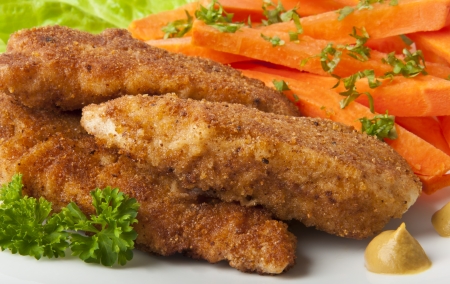 chicken fried in breadcrumbs with vegetablesの写真素材