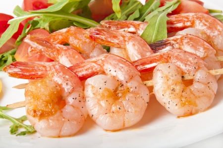 Fresh grilled shrimps with lemon on white plateの写真素材