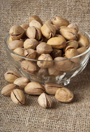roasted pistachios on a natural wooden background