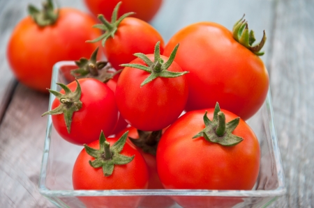 Freshly harvested summer cherry tomatoes on wooden backgroundの写真素材