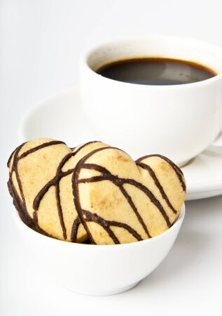 cup of coffee and cookies in a heart-shaped chocolateの写真素材