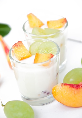 Fresh peach and grape yogurt in glassの写真素材