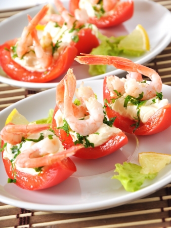 Halves of tomatoes filled with shrimp cocktailの写真素材
