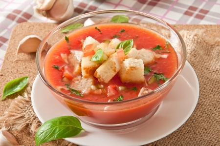 cold gazpacho with garlic croutons in glass bowlの写真素材