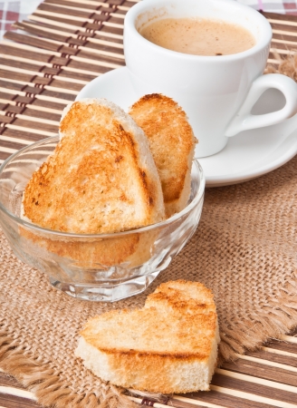 heart-shaped toast  and a cup of coffeeの写真素材