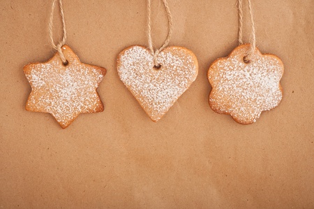Gingerbread cookie hanging on a paper background  Christmas decoration 