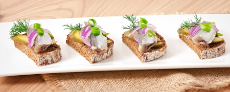 Sandwiches of rye bread with herring, onions and herbs の写真素材