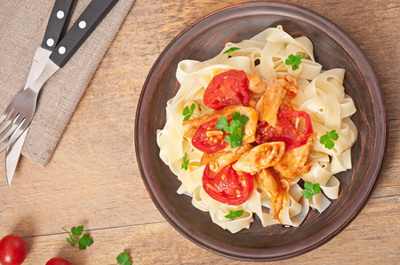 tagliatelle pasta with tomatoes and chickenの写真素材