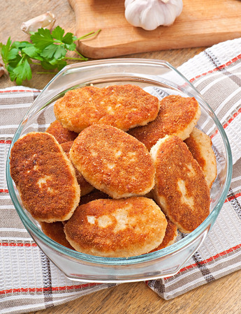 Chicken cutlets in a glass bowlの写真素材