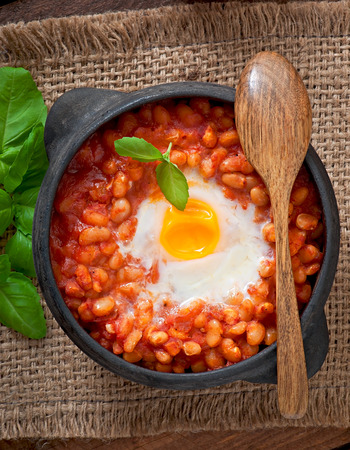 Baked eggs with beans in tomato sauce in the Mexican styleの写真素材