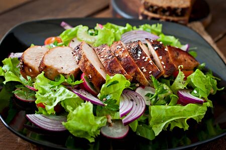 Fresh vegetable salad with grilled chicken breastの写真素材