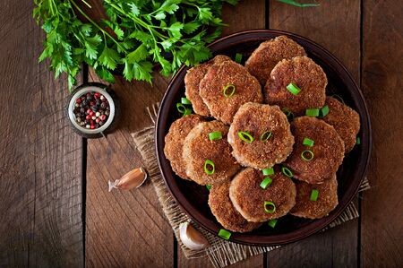 Juicy delicious meat cutlets on a wooden table in a rustic style.の写真素材