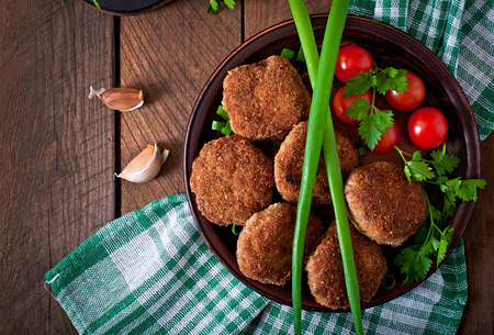 Juicy delicious meat cutlets on a wooden table in a rustic style.