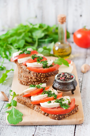 Useful dietary sandwiches with mozzarella tomatoes and rye breadの写真素材