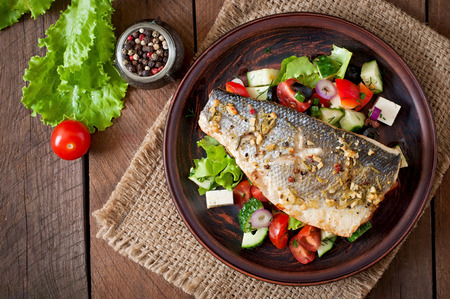 Baked seabass with Greek saladの写真素材