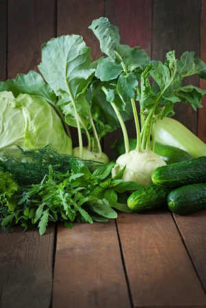 Useful green vegetables on a wooden backgroundの写真素材