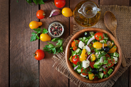 Greek salad with fresh vegetables, feta cheese and black olives Greek salad with fresh vegetables, feta cheese and black olives
