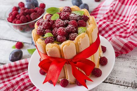 Cake "Charlotte " with raspberries and plums.の写真素材
