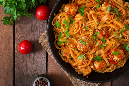 Pasta linguine with meatballs in tomato sauce. Top view Pasta linguine with meatballs in tomato sauce. Top view
