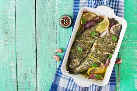 Baked trout on a bright wooden background. Top viewの写真素材