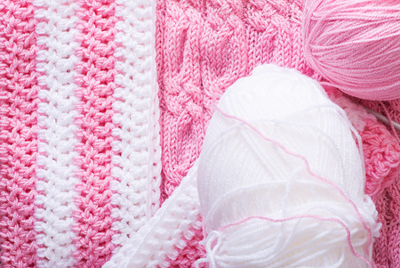 Cozy knitted background, thread and needles. Top view