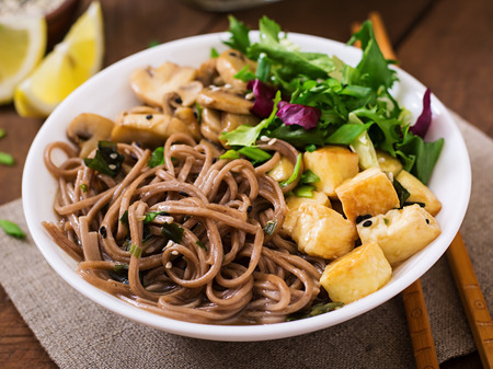 Miso and soba noodle soup with roasted tofu and mushroomsの写真素材