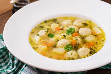 Dietary soup with chicken meatballs and stalks of celeryの写真素材