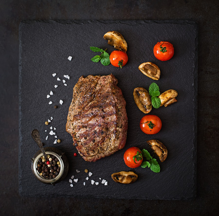 Juicy steak medium rare beef with spices and grilled vegetables. Top viewの写真素材