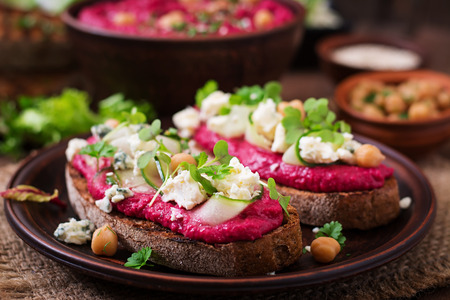 Vegan sandwiches with beetroot hummus, cucumber and blue cheeseの写真素材