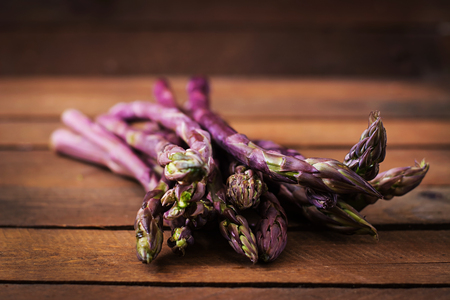 Bunch of fresh asparagus on a wooden backgroundの写真素材