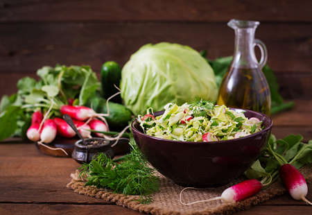 Vitamin salad of young vegetables: cabbage, radish, cucumber and fresh herbsの写真素材