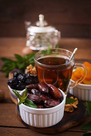 Mix dried fruits (date palm fruits, prunes, dried apricots, raisins) and nuts, and traditional Arabic tea. Ramadan (Ramazan) food.の写真素材