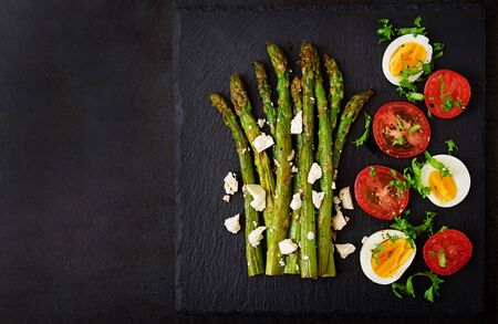 Warm salad of roasted asparagus, feta cheese, tomatoes and eggs. Top viewの写真素材