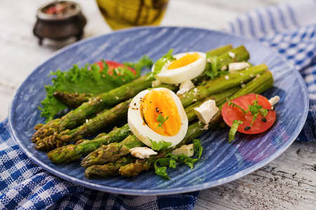 Warm salad of roasted asparagus, feta cheese, tomatoes and eggs.の写真素材