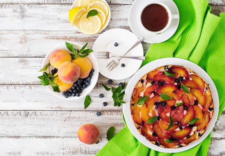 Delicate biscuit pie with peaches and blueberries. Top viewの写真素材