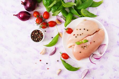 Raw chicken fillet prepared for baking in a plate. Top viewの写真素材