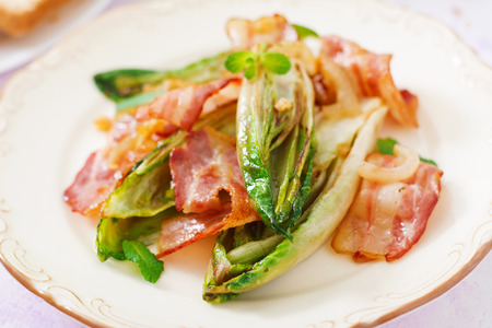 Baked chicory with bacon, onions and herbs.の写真素材