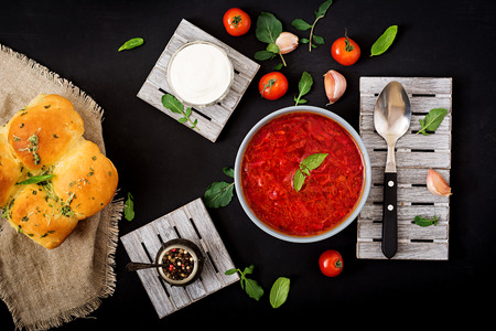 Traditional Ukrainian Russian vegetable borscht soup  on blue bowl. Flat lay. Top view