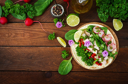 Healthy mexican corn tacos with boiled chicken breast, spinach, radish and paprika. Flat lay. Top viewの写真素材