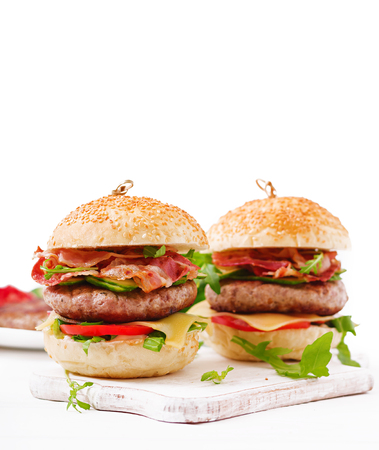 Big sandwich - hamburger burger with beef, cheese, tomato, cucumber and fried bacon.の写真素材