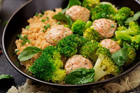 Baked meatballs of chicken fillet with garnish with quinoa and boiled broccoli. Proper nutrition. Sports nutrition. Dietary menuの写真素材