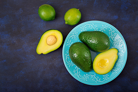 Three ripe avocados on a dark table. Healthy food concept. Top viewの写真素材