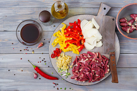 Ingredients for cooking stir-fry from chicken hearts, paprika and onions. Chinese cuisine. Top viewの写真素材