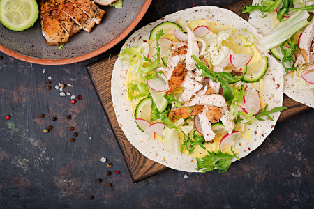 Healthy mexican tacos with baked chicken breast, cucumber, radish and lettuce. Flat lay. Top viewの写真素材