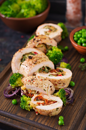 Chicken roll with stuffed sun-dried tomatoes and cheese.の写真素材