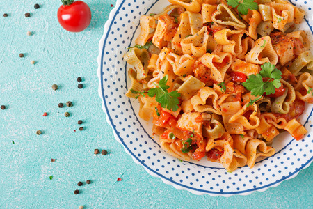 Pasta in the shape of hearts with chicken and tomatoes in tomato sauce. Top viewの写真素材
