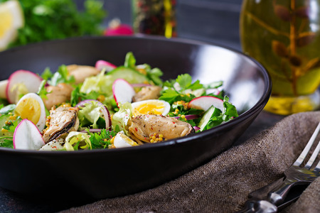 Dietary salad with mussels, quail eggs, cucumbers, radish and lettuce. Healthy food. Seafood salad.の写真素材